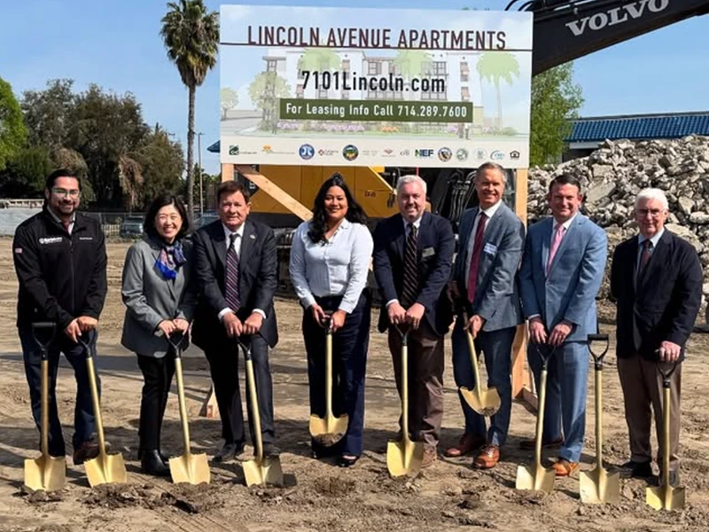 Jessie Lopez and 7 other people breaking ground on a housing project holding golden shovels.