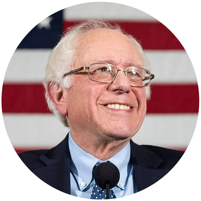 Senator Bernie Sanders smiling in front of an American flag.