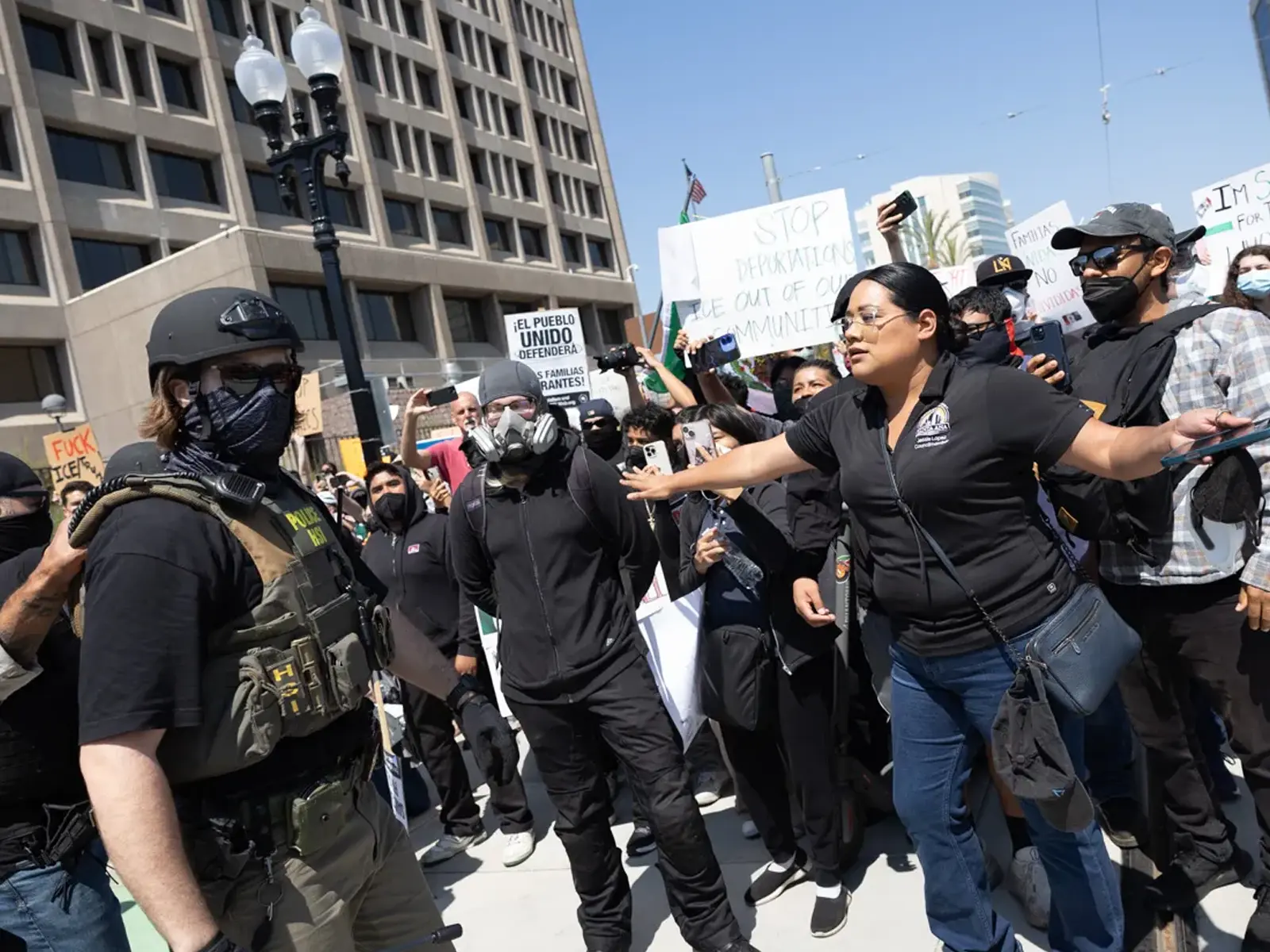 Jessie Lopez protecting protestors at an ICE protest in Santa Ana.