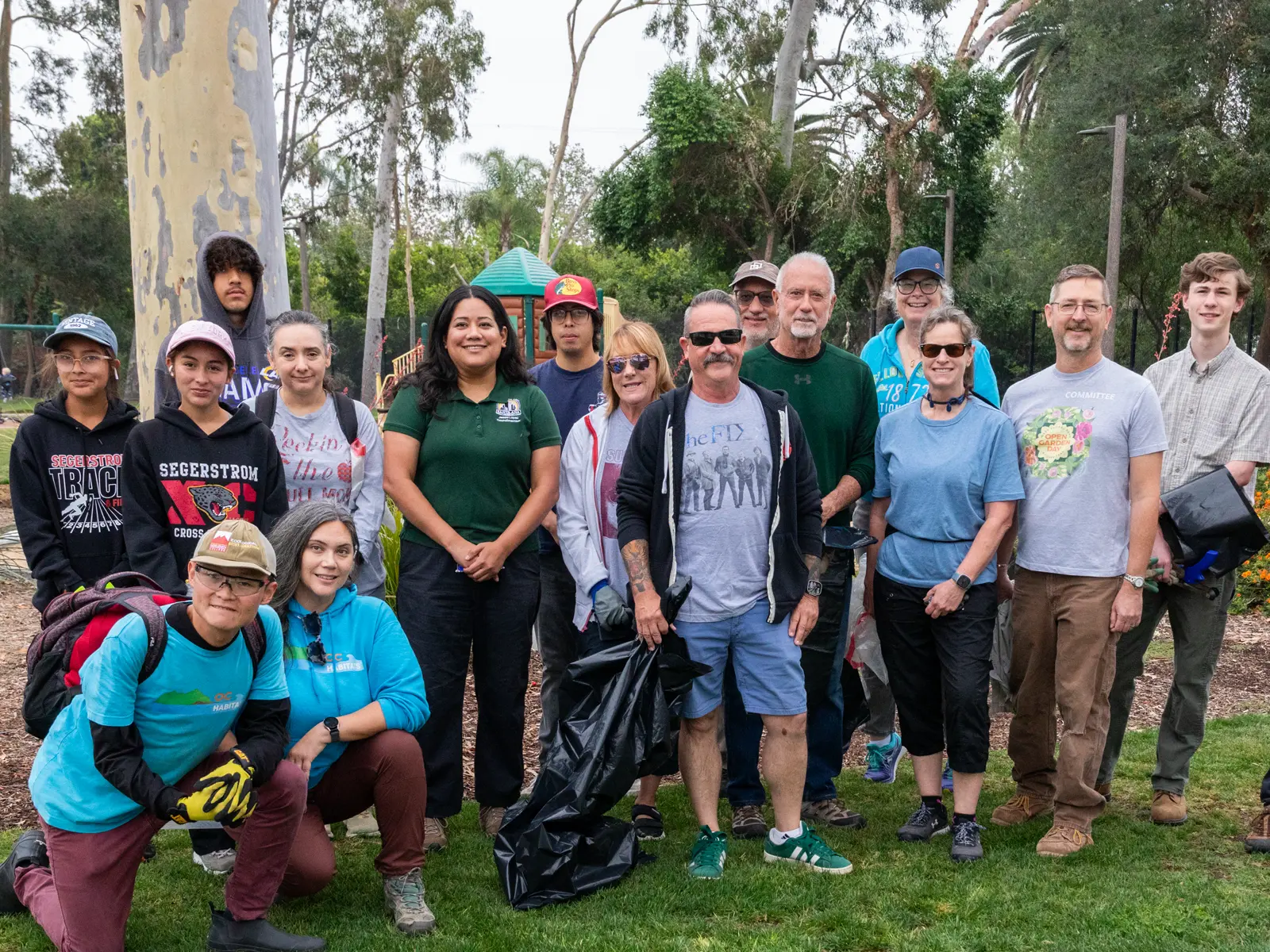 Jessie Lopez smiling with Fisher Park residents and volunteers at a Santiago Creek Cleanup.