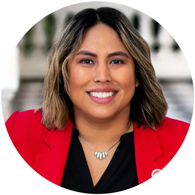 California Senator Caroline Menjivar smiling, wearing a red blazer.