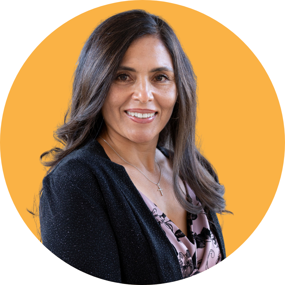 Orange Councilmember Ana Gutierrez smiling in front of an orange background.