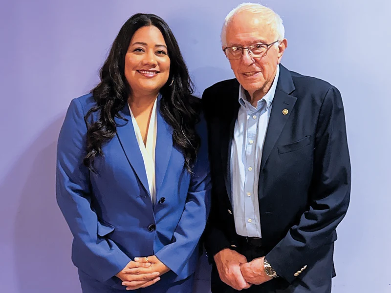 Jessie Lopez smiling alongside Senator Bernie Sanders.
