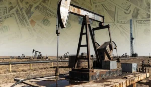 An oil derrick on flat land in front of a smoggy sky with money overlaid.